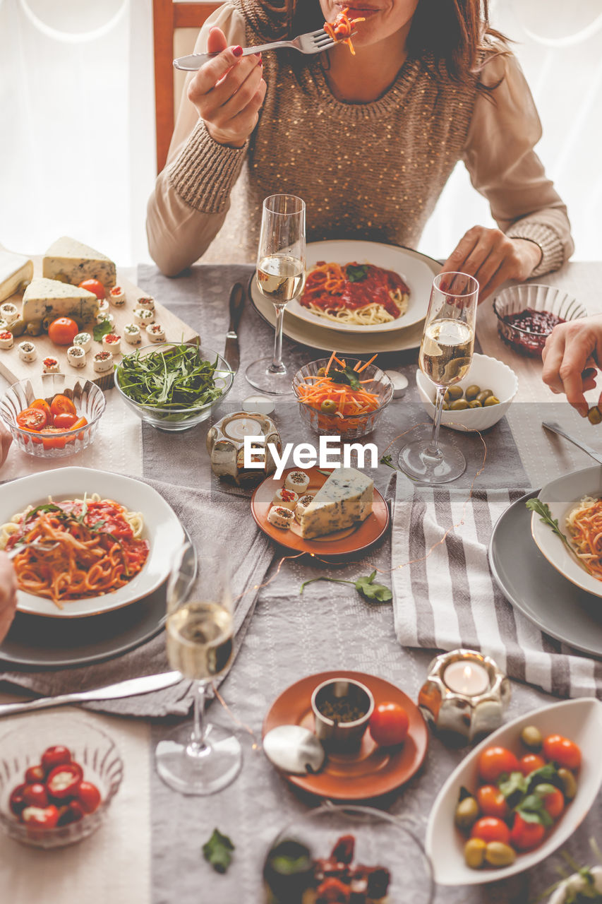 Midsection of woman eating food at table