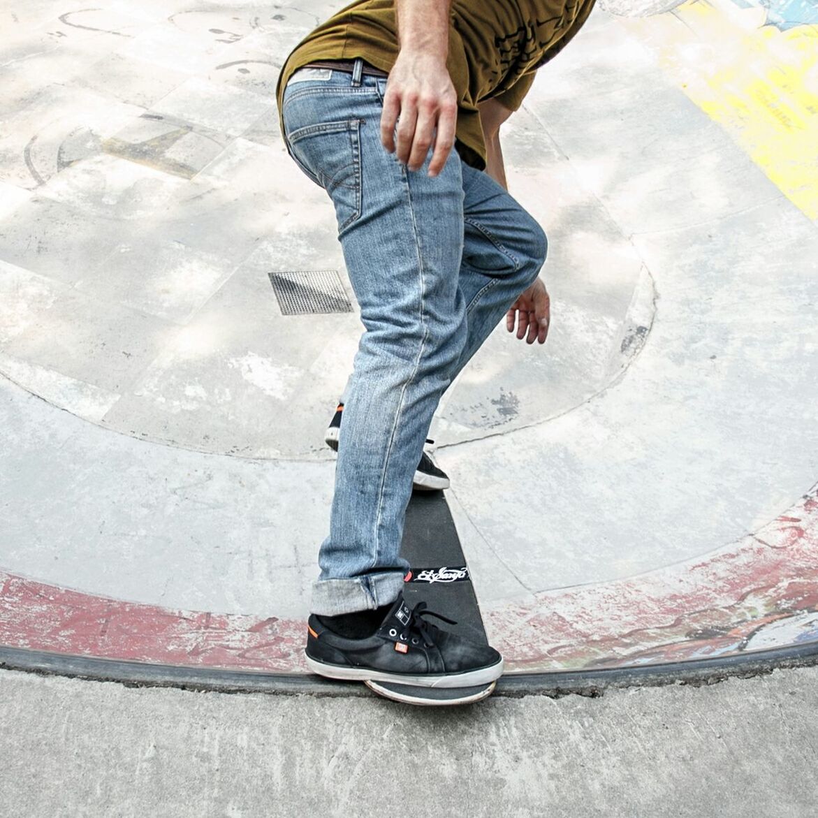 Low section of man with skateboard at ramp