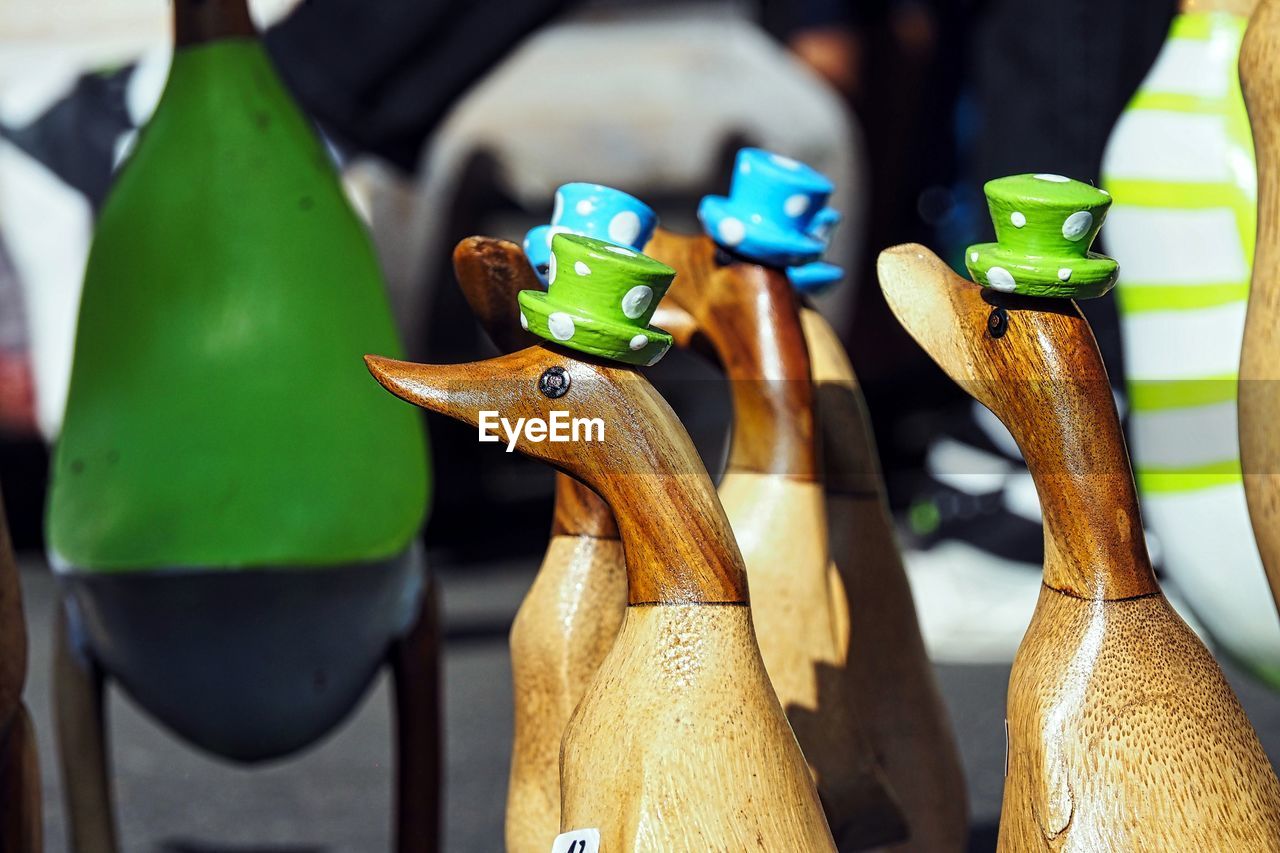 Funny wooden ducks with hats