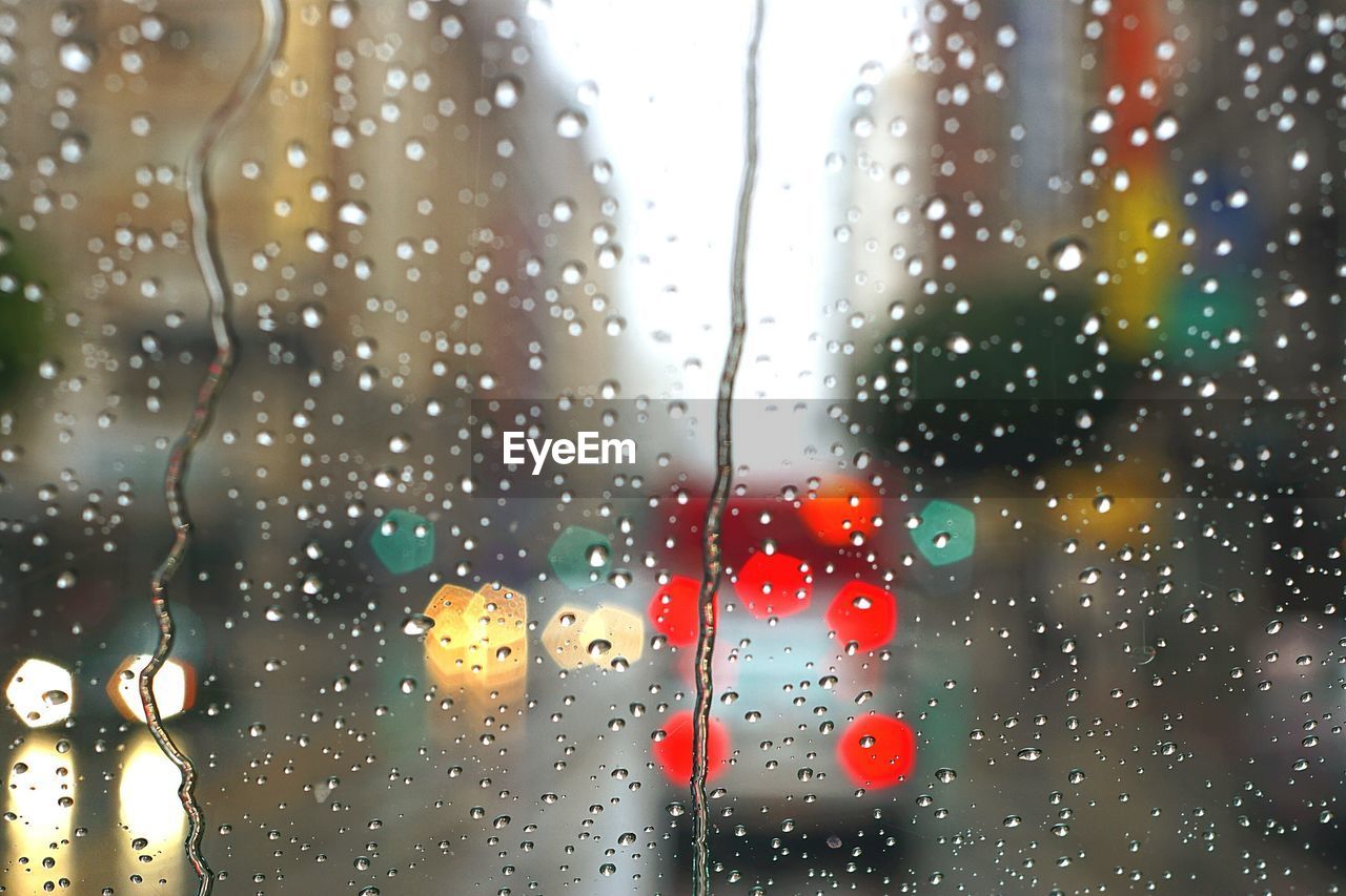 Close-up of wet car windshield during rainy season