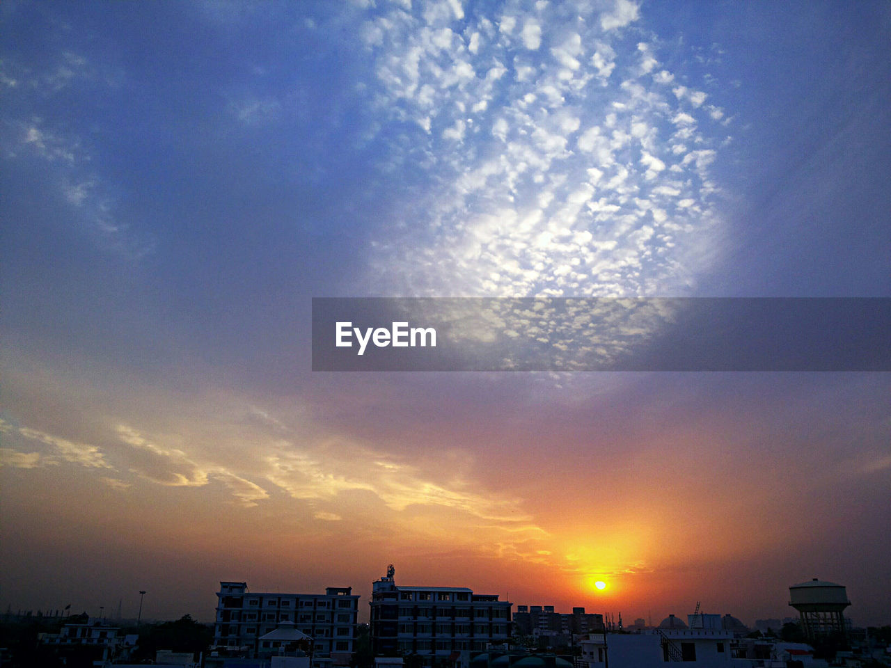 VIEW OF BUILDINGS AT SUNSET