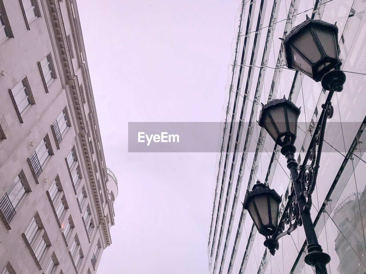 Low angle view of street light against buildings