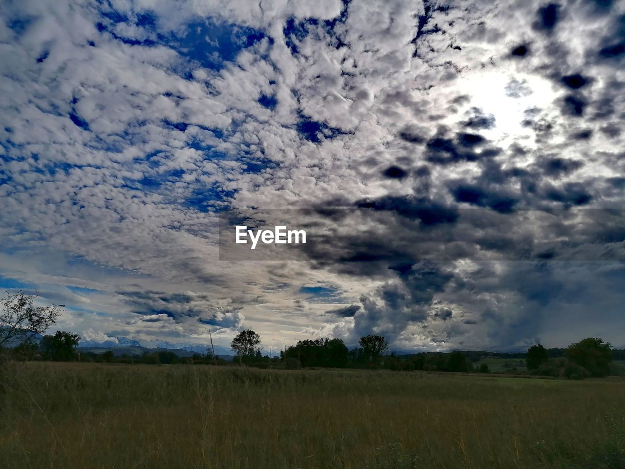 SCENIC VIEW OF LAND AGAINST SKY DURING SUNSET