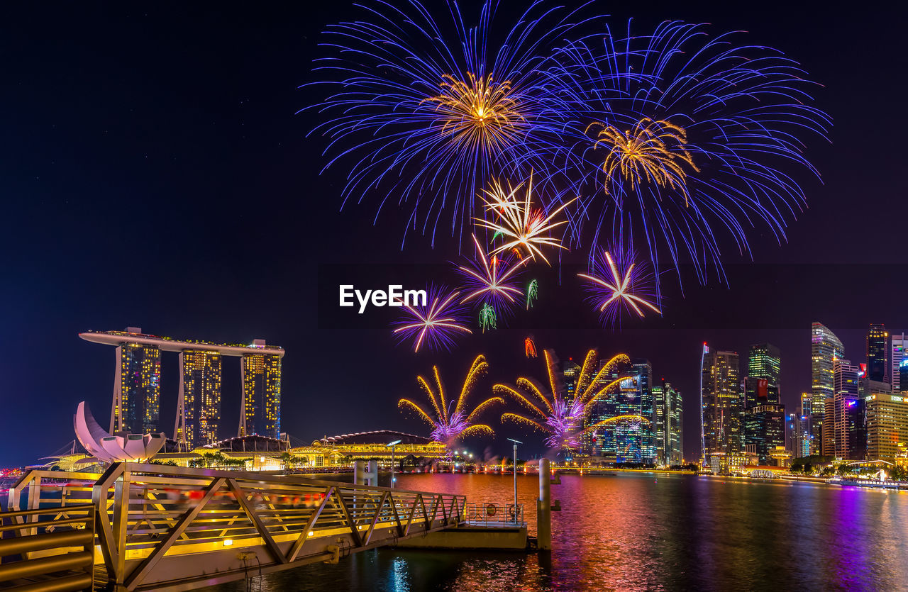 Low angle view of firework display against sky at night