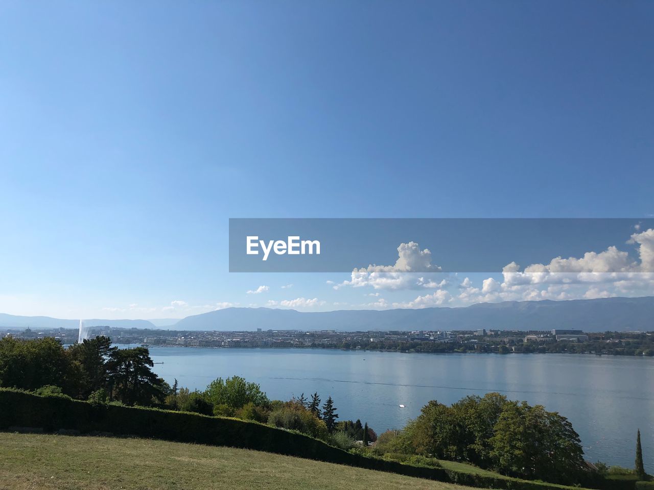 PANORAMIC VIEW OF LAKE AGAINST BLUE SKY