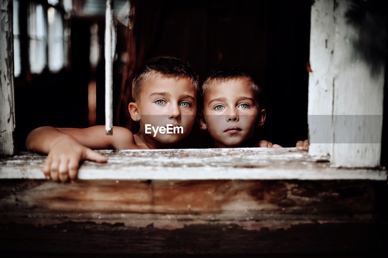 PORTRAIT OF CUTE BOY PEEKING AT HOME