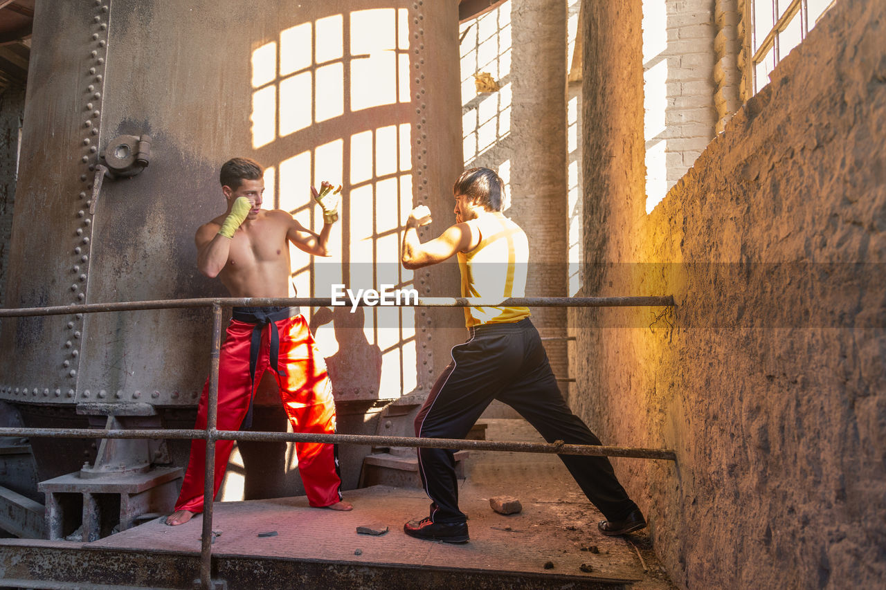 Men boxing at construction site