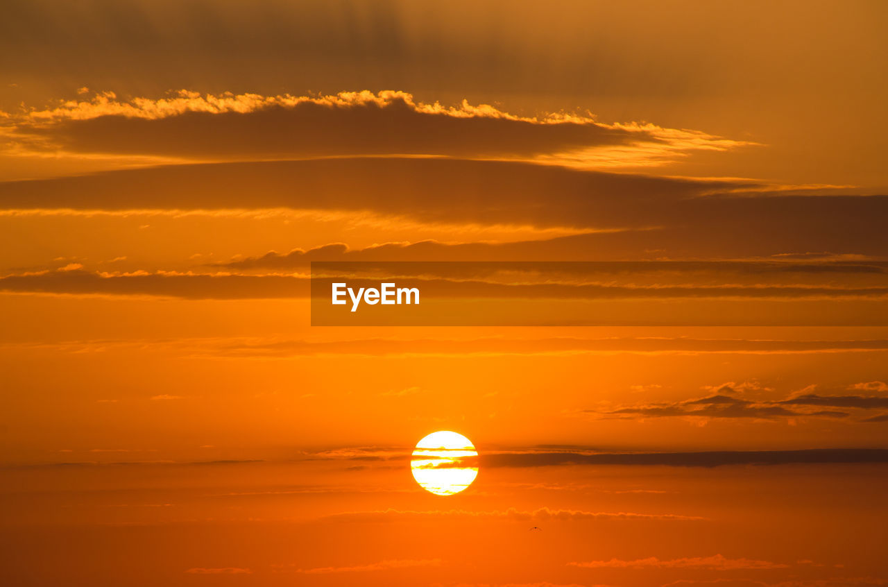 Full frame shot of orange sky with sun