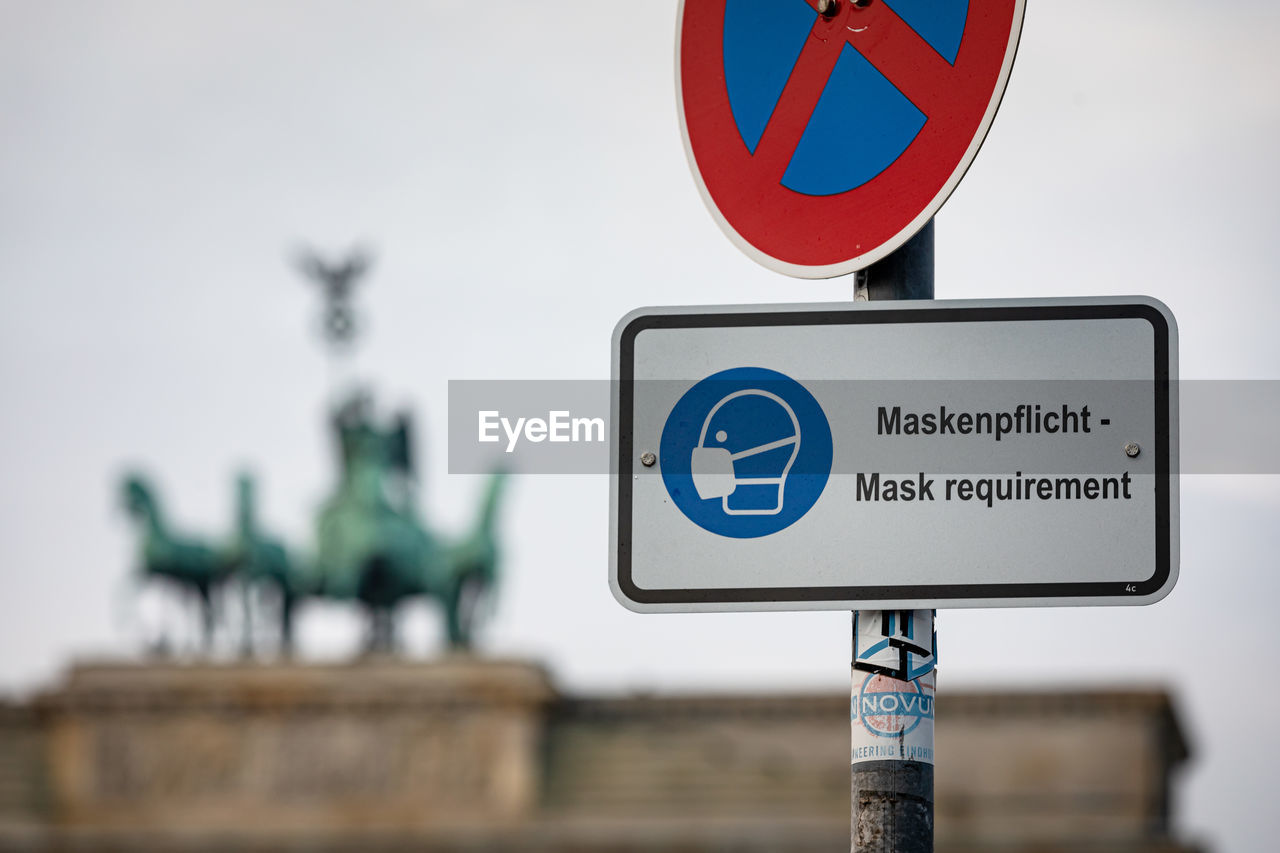 Close-up of road sign against clear sky