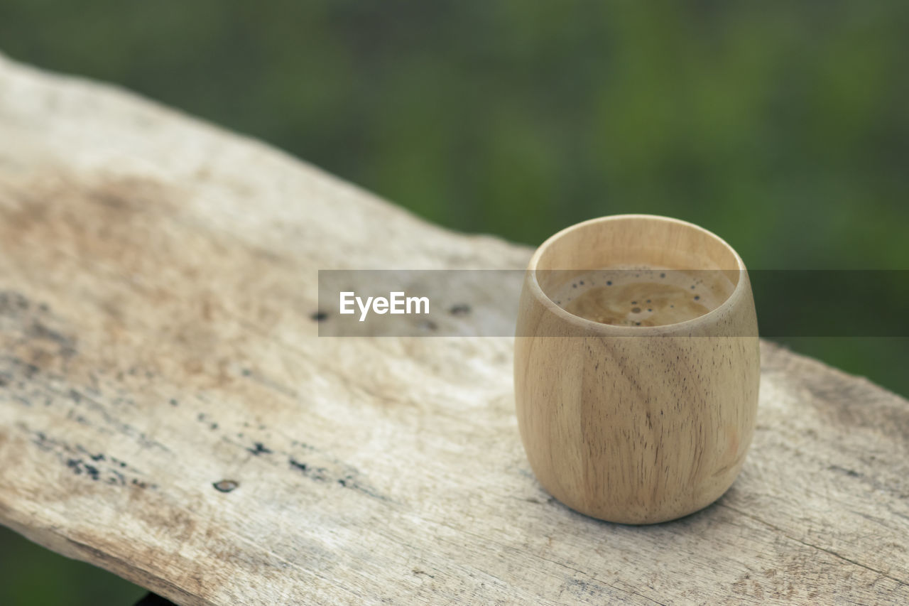 Selective focus, bamboo coffee cup, beautiful shape, placed on a wooden balcony 