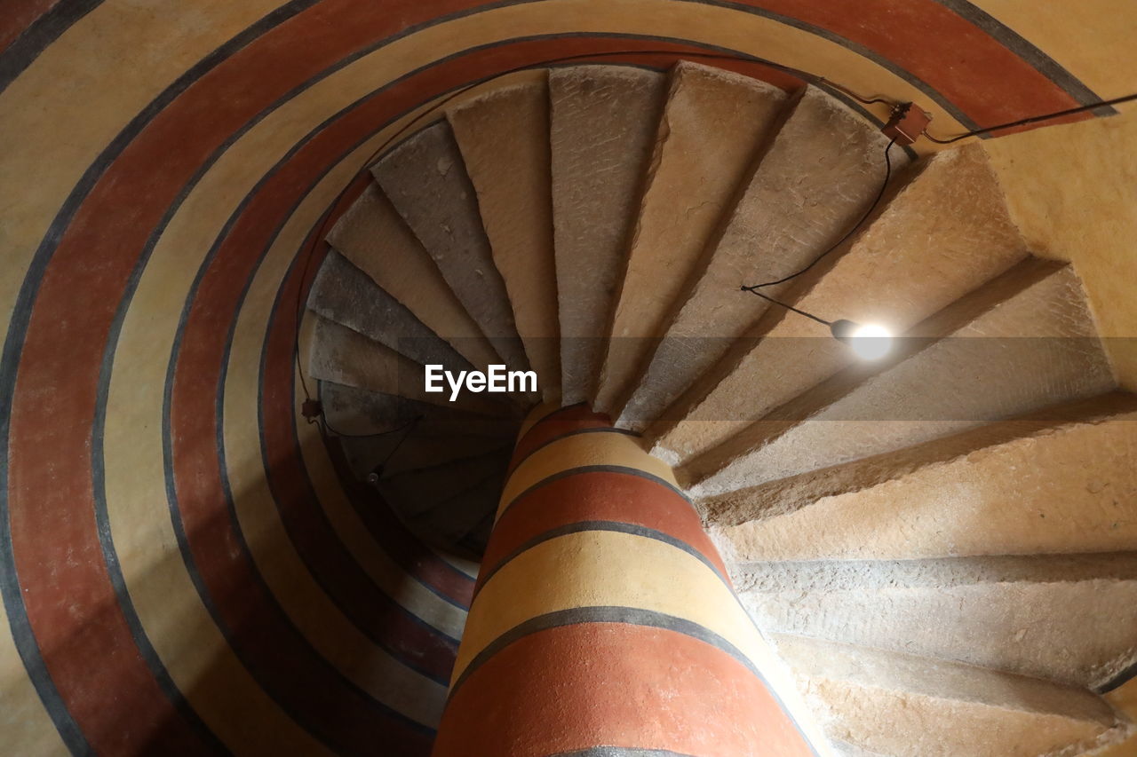 LOW ANGLE VIEW OF SPIRAL STAIRCASE OF LIGHT