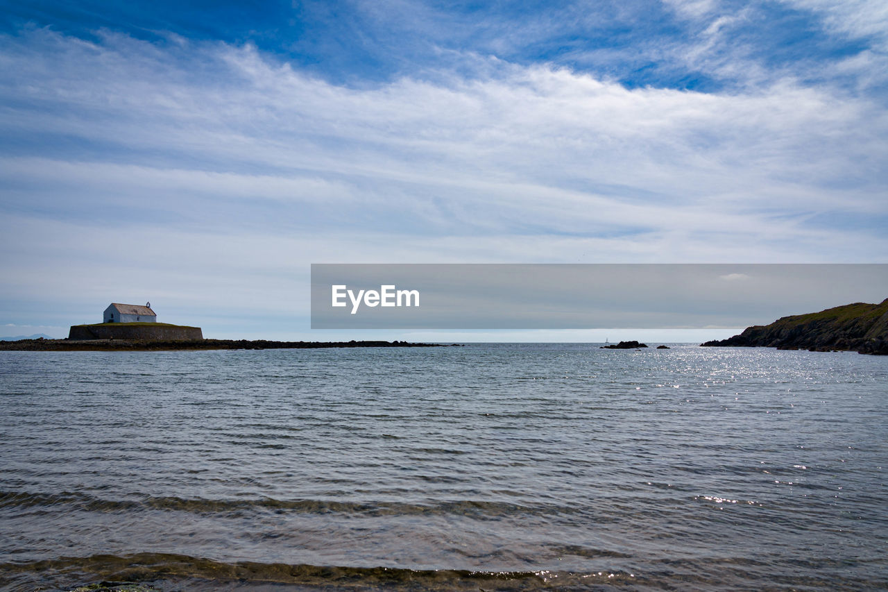 SCENIC VIEW OF SEA AGAINST SKY AND BUILDINGS