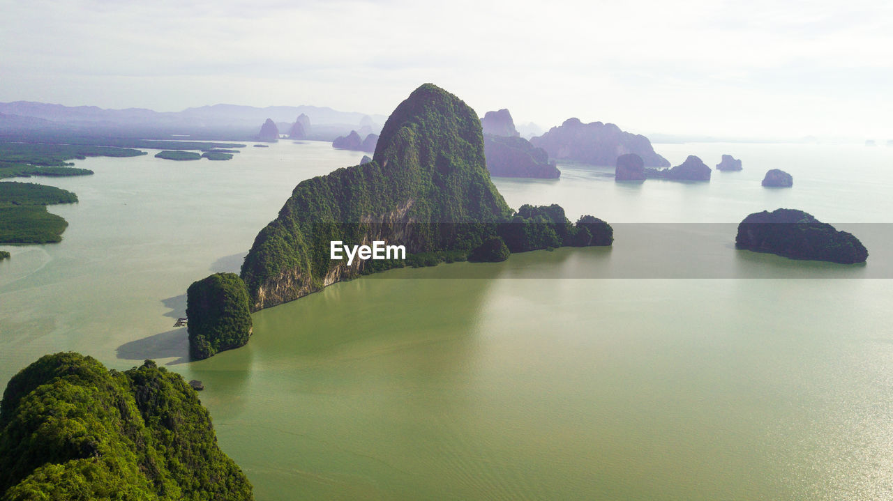 High angle view of rock formations in sea against sky