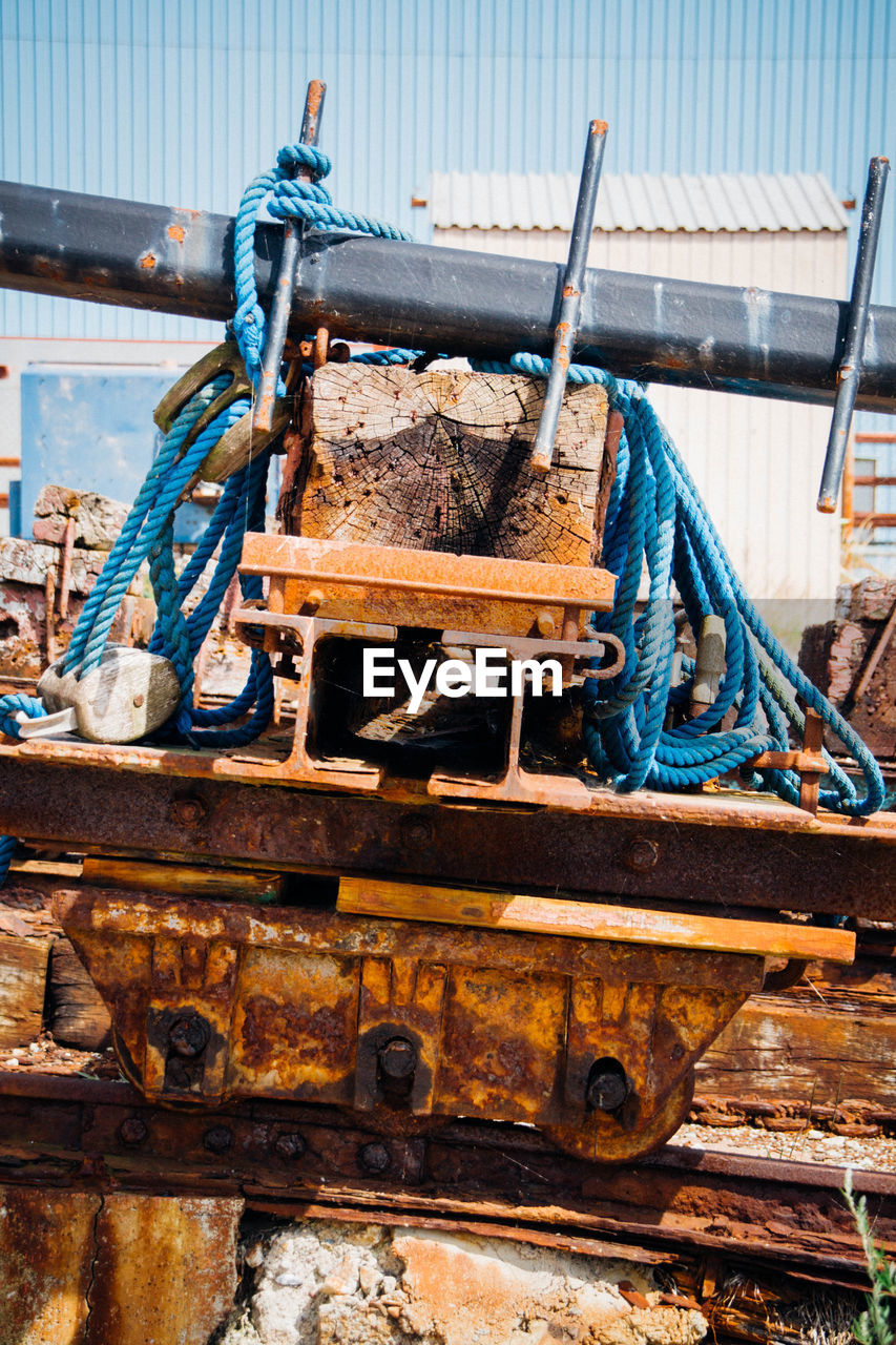 Rope tied on rusty metals and wood at shunting yard