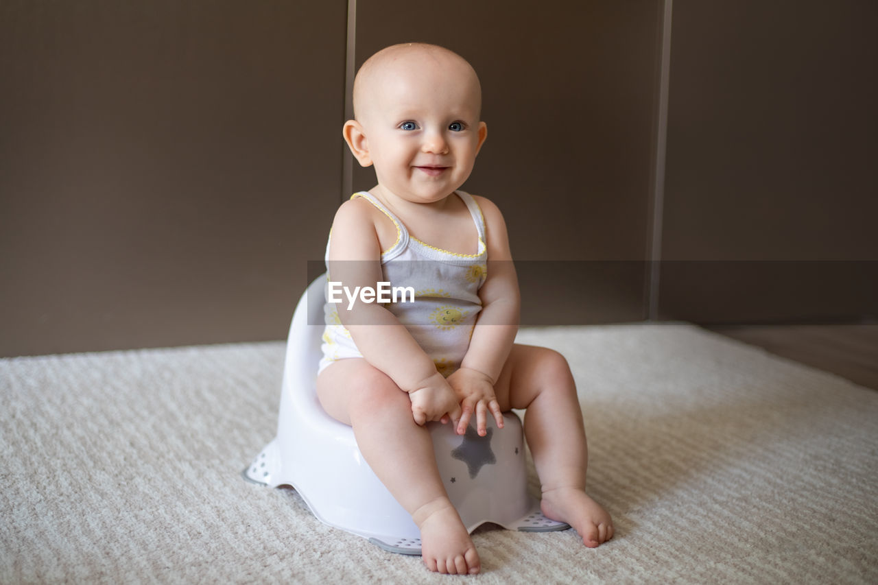 portrait of cute baby boy lying on floor