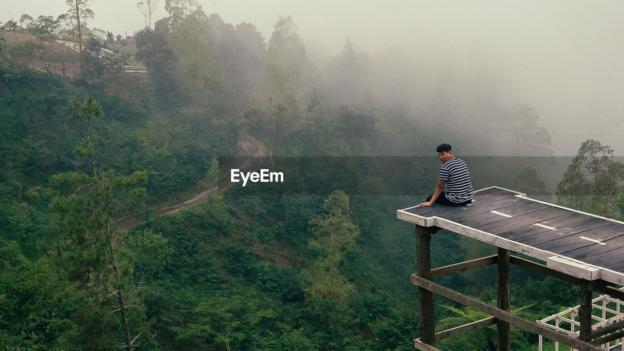 Man looking at view of mountain