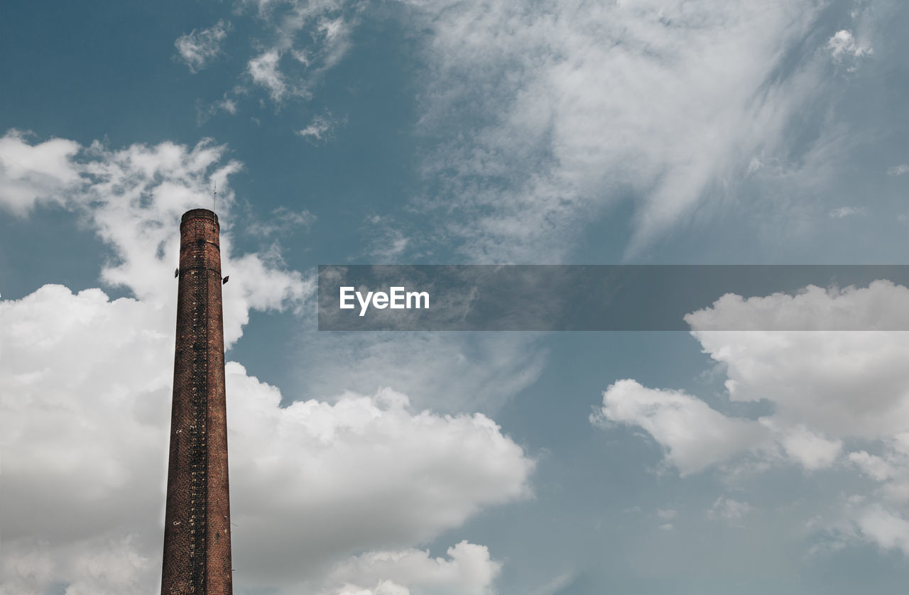 Low angle view of smoke stack against sky