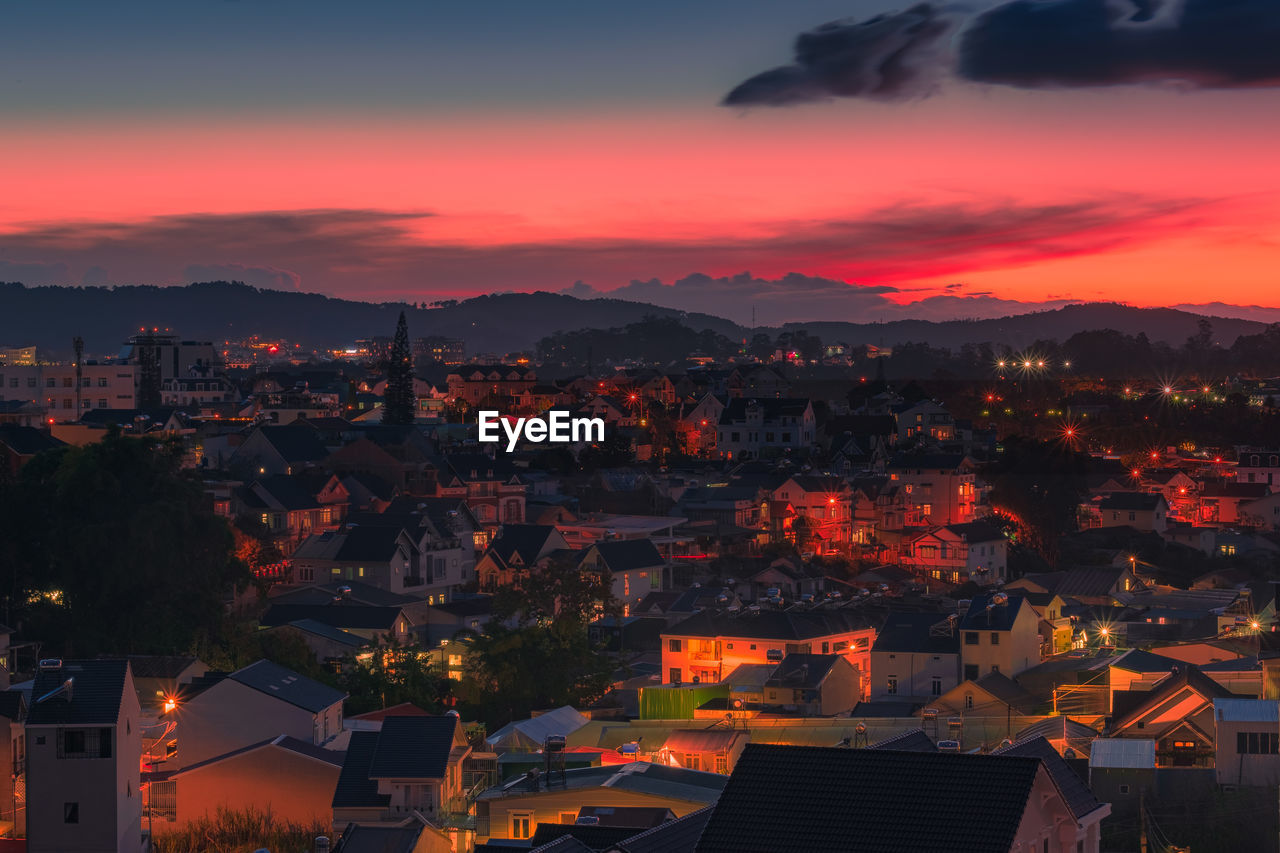 High angle view of illuminated buildings against sky during sunset