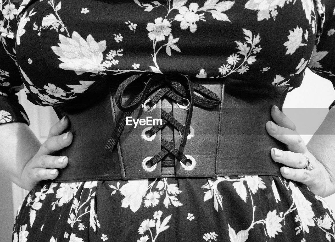 Midsection of woman with hands on hip