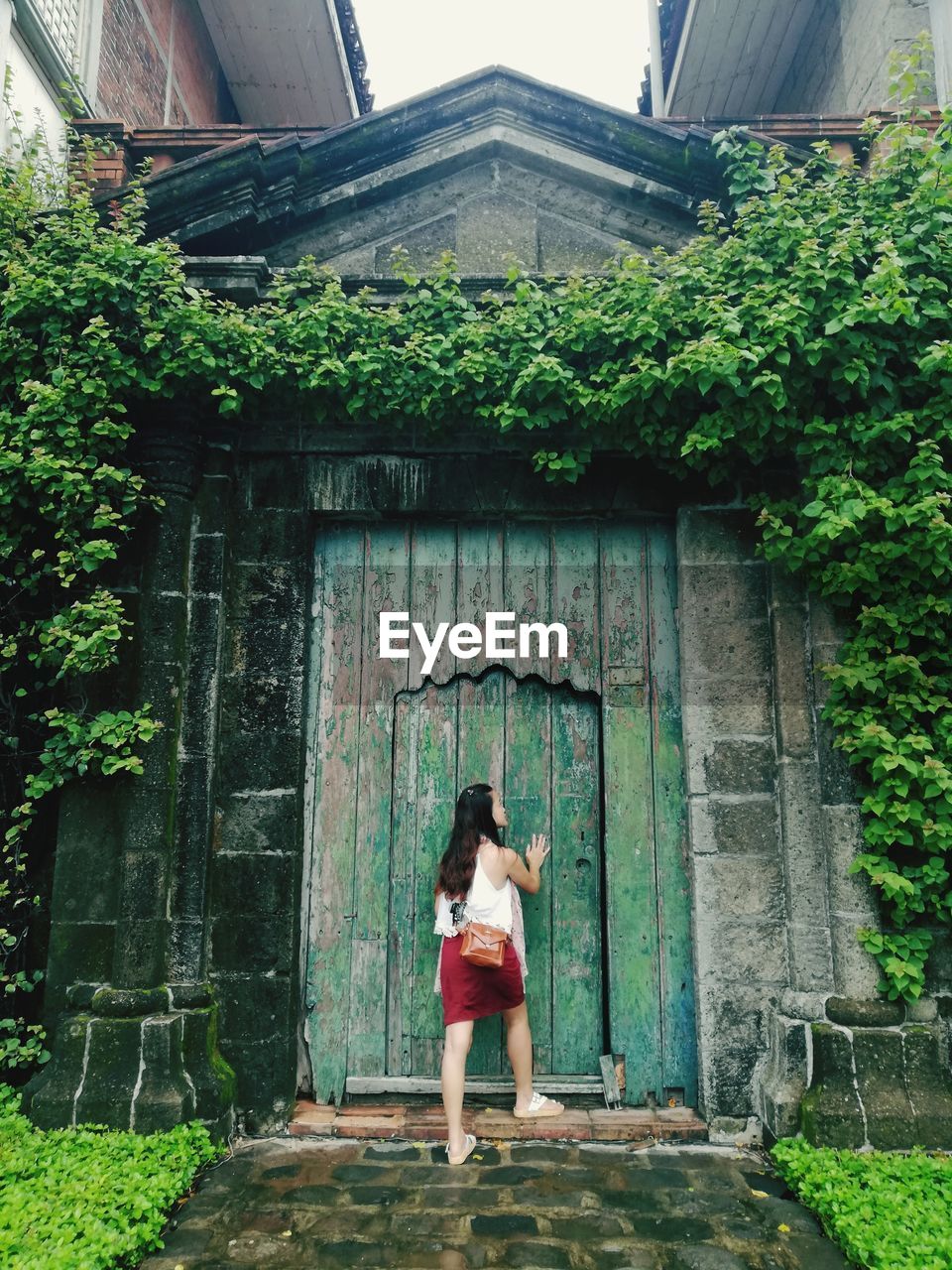 Rear view of woman standing by door