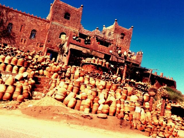 LOW ANGLE VIEW OF RUINED STRUCTURE AGAINST CLEAR BLUE SKY