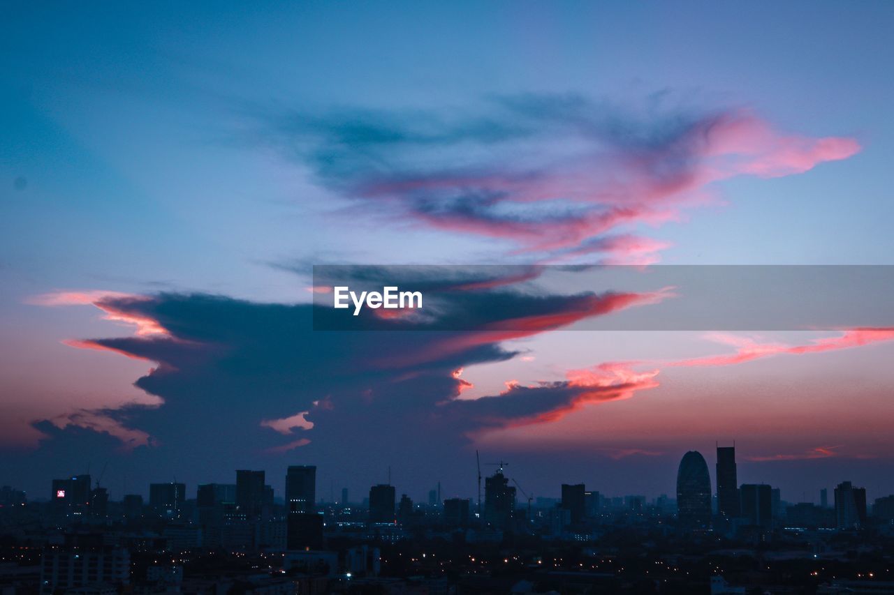 CITYSCAPE AGAINST DRAMATIC SKY DURING SUNSET