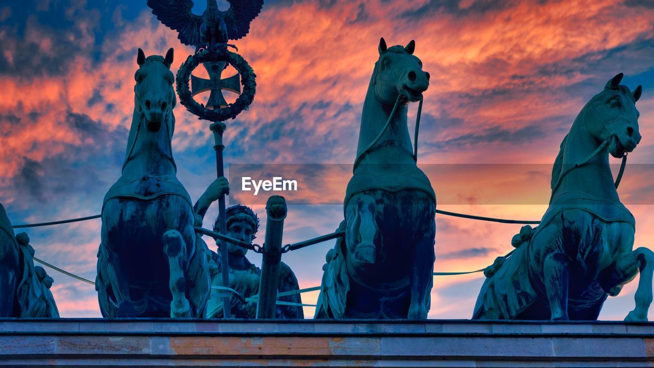 Low angle view of statue against sky during sunset