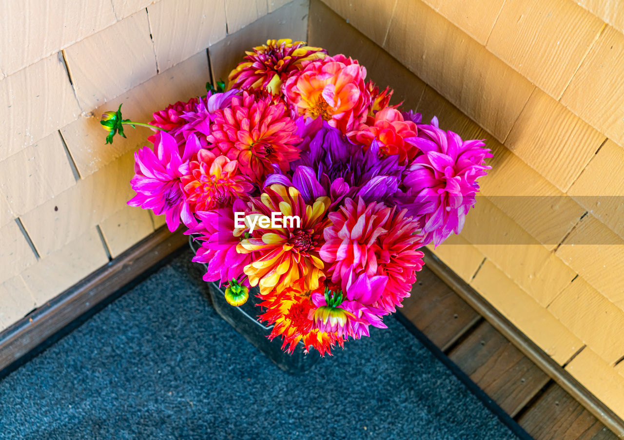 flower, flowering plant, pink, plant, yellow, fragility, multi colored, freshness, beauty in nature, bouquet, nature, no people, high angle view, flower head, red, petal, purple, floristry, close-up, flooring, inflorescence, art, indoors