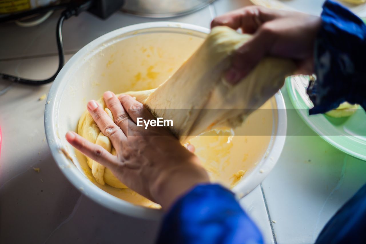 Cropped hands of woman preparing food in kitchen