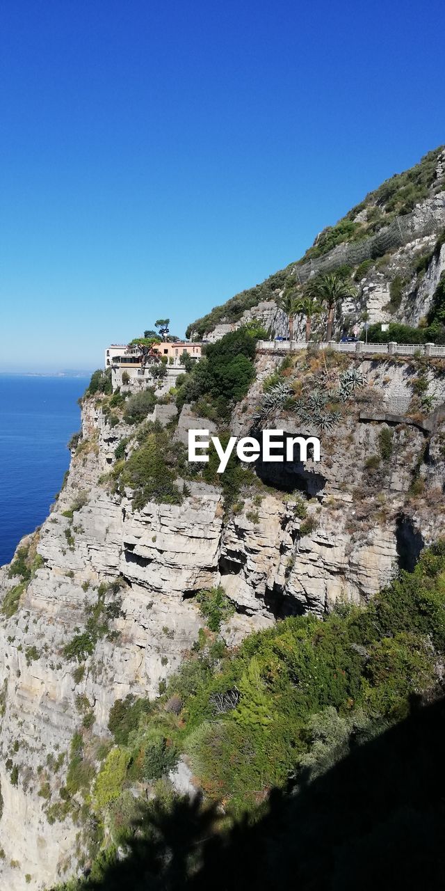 SCENIC VIEW OF ROCKS AGAINST CLEAR BLUE SKY