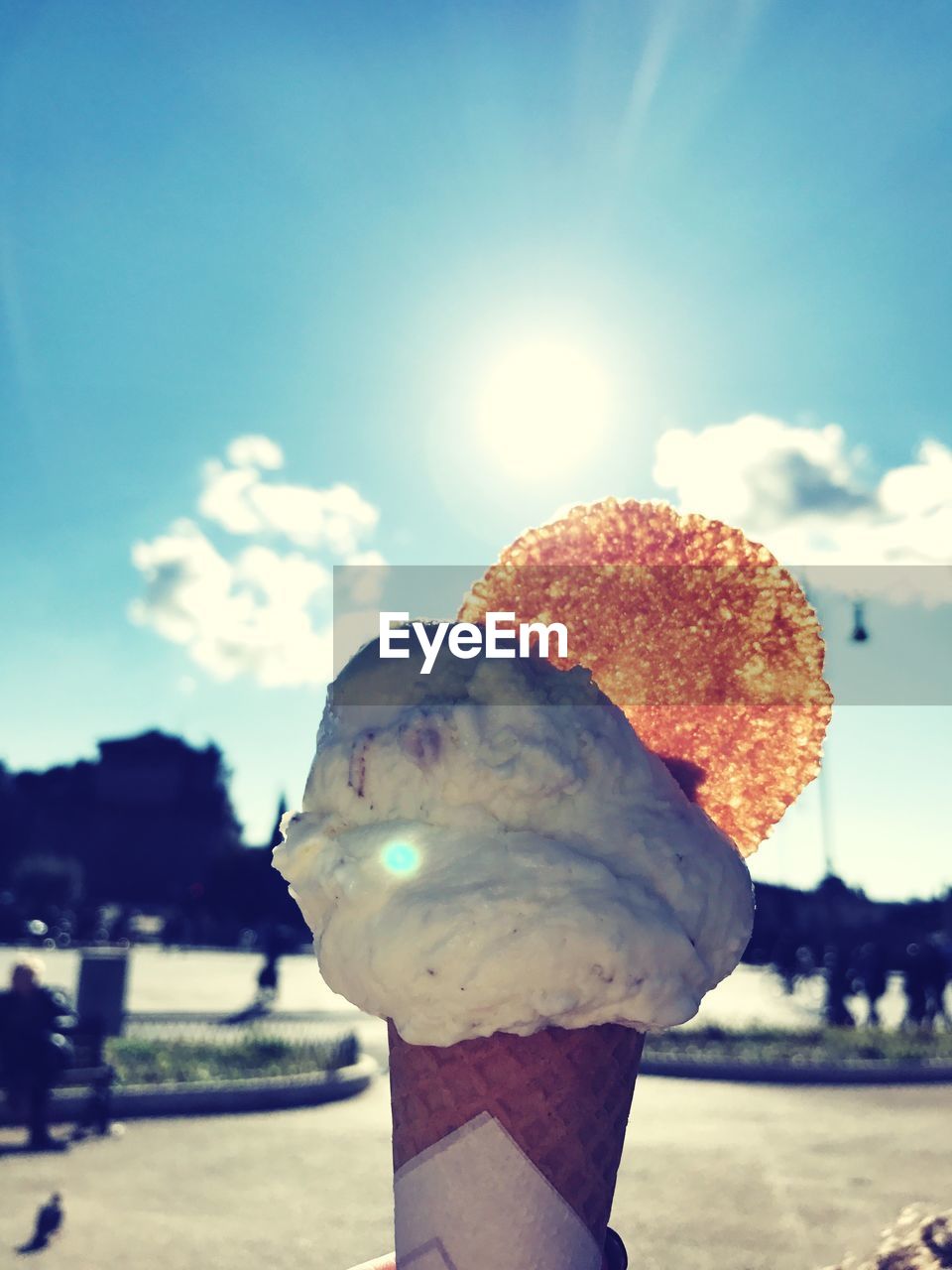 Close-up of ice cream cone against sky