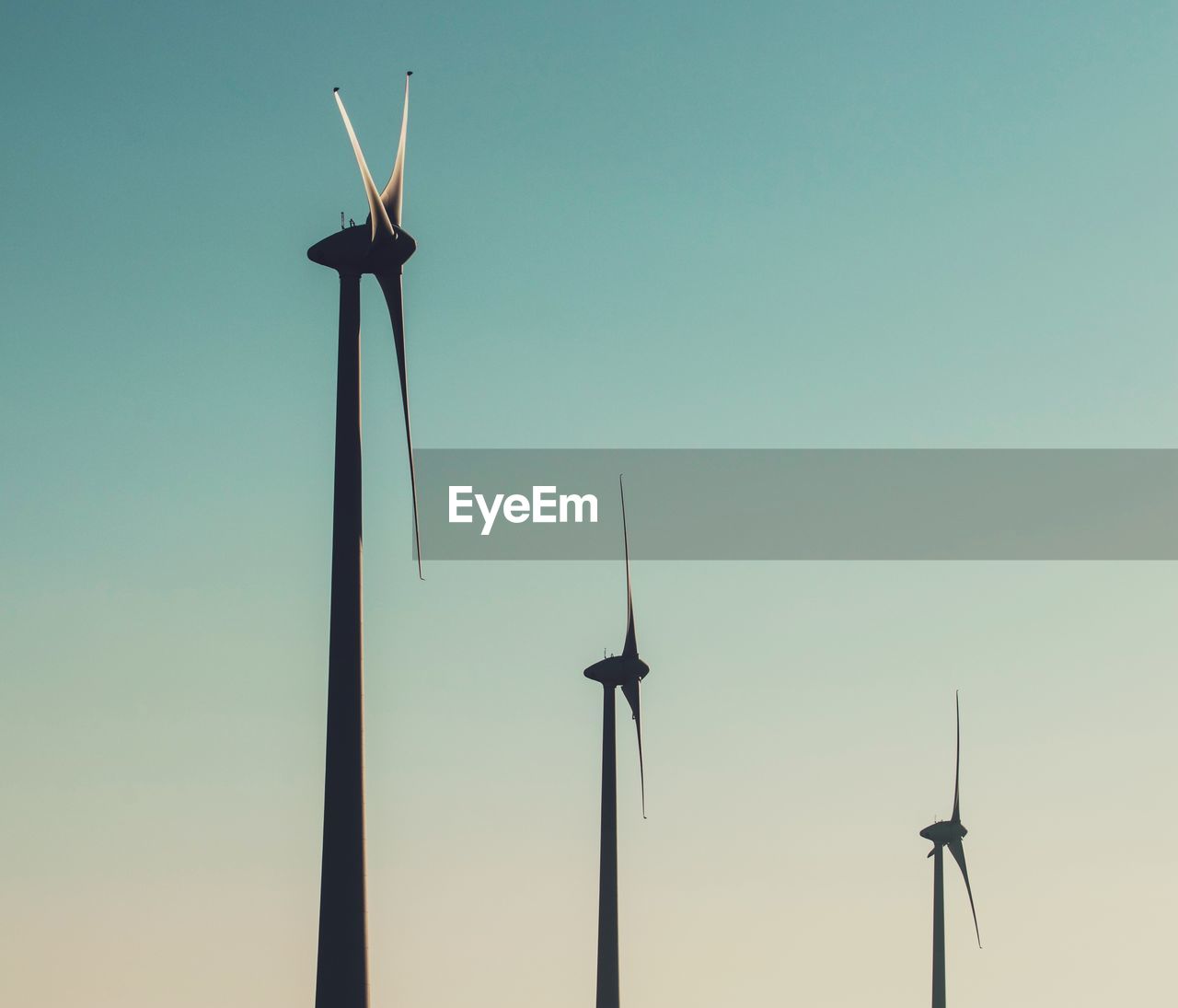 LOW ANGLE VIEW OF WINDMILLS AGAINST SKY