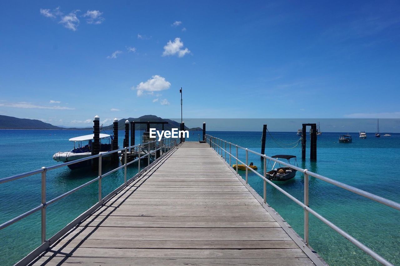 Pier over sea against sky