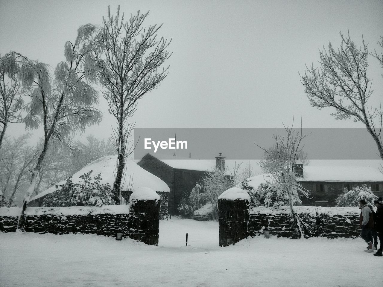 Snow covered houses against clear sky