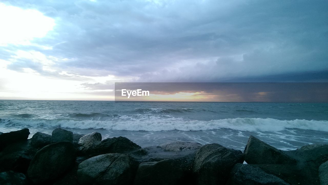 Scenic view of sea against cloudy sky