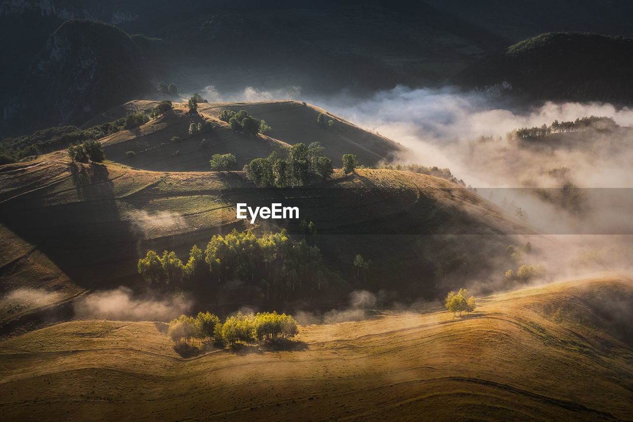 View from drone of incredible atmosphere with foggy hills at sunrise.