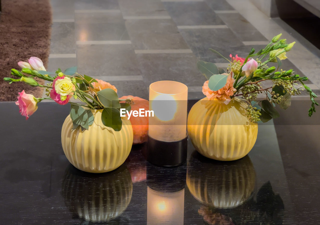 yellow, flower, plant, flowering plant, nature, freshness, floristry, food and drink, floral design, food, no people, vase, arrangement, art, still life, table, decoration, outdoors, high angle view, beauty in nature, flowerpot, wellbeing, healthy eating, flower arrangement