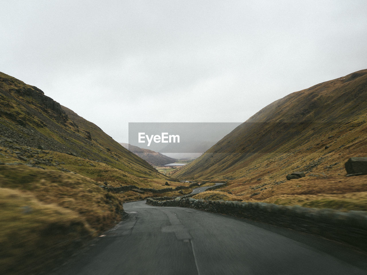 Road amidst mountains against sky