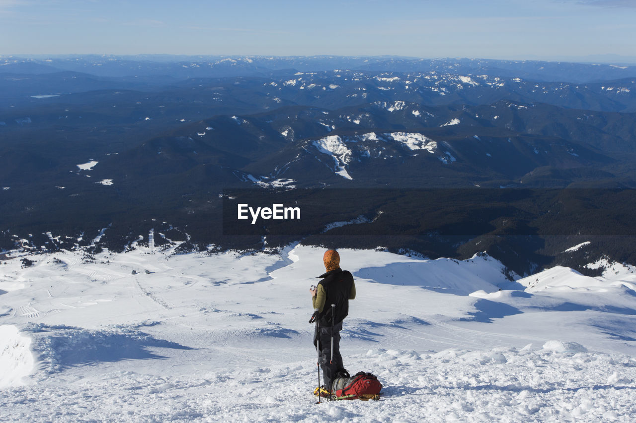A man climbs to the summit of mt. hood in oregon.