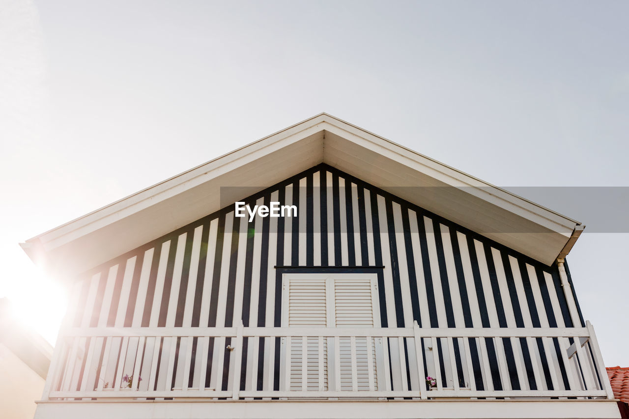 Colorful striped wooden beach houses at the promenade of costa nova, aveiro, portugal