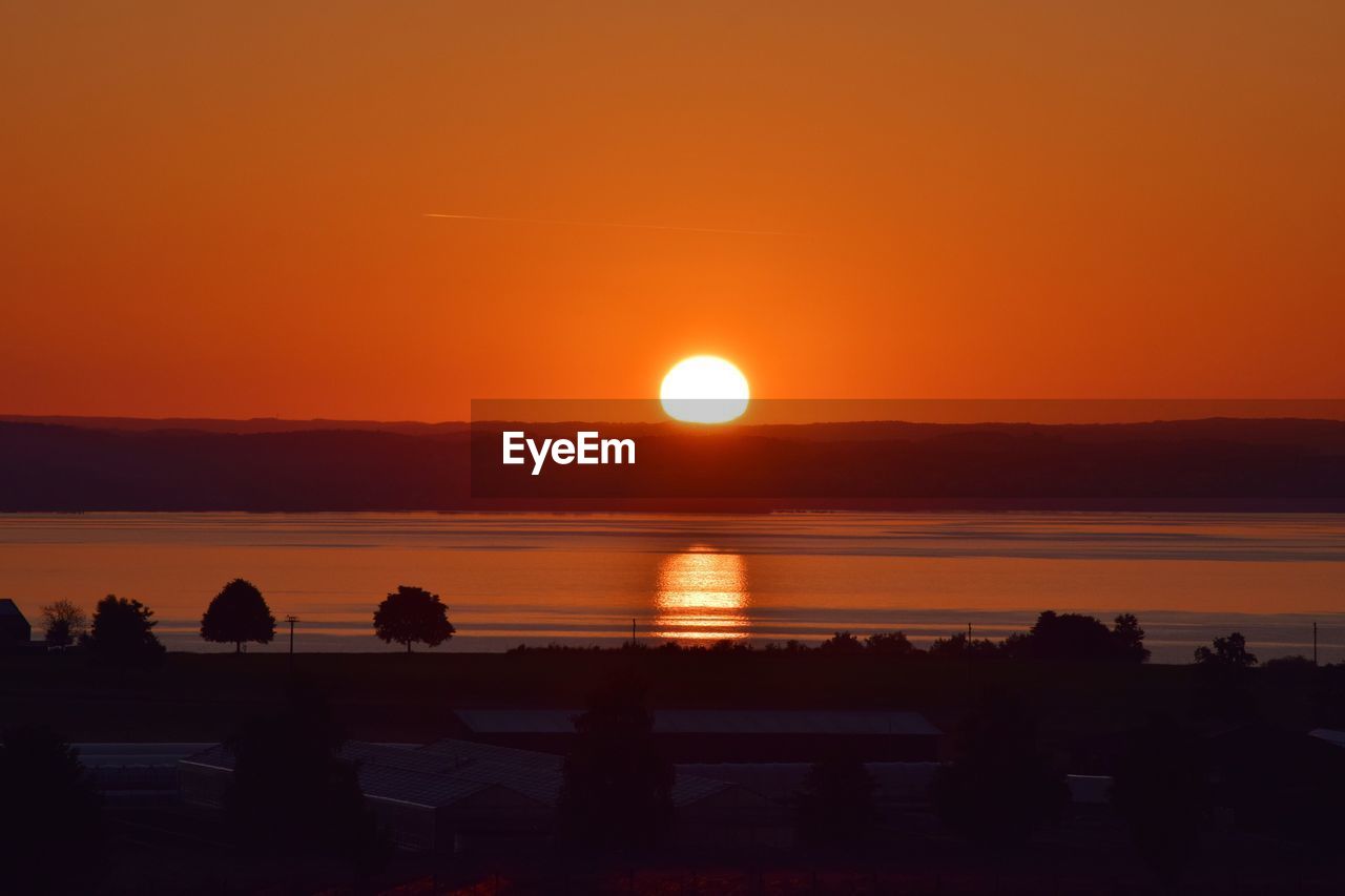 SCENIC VIEW OF SEA AGAINST ORANGE SUNSET SKY