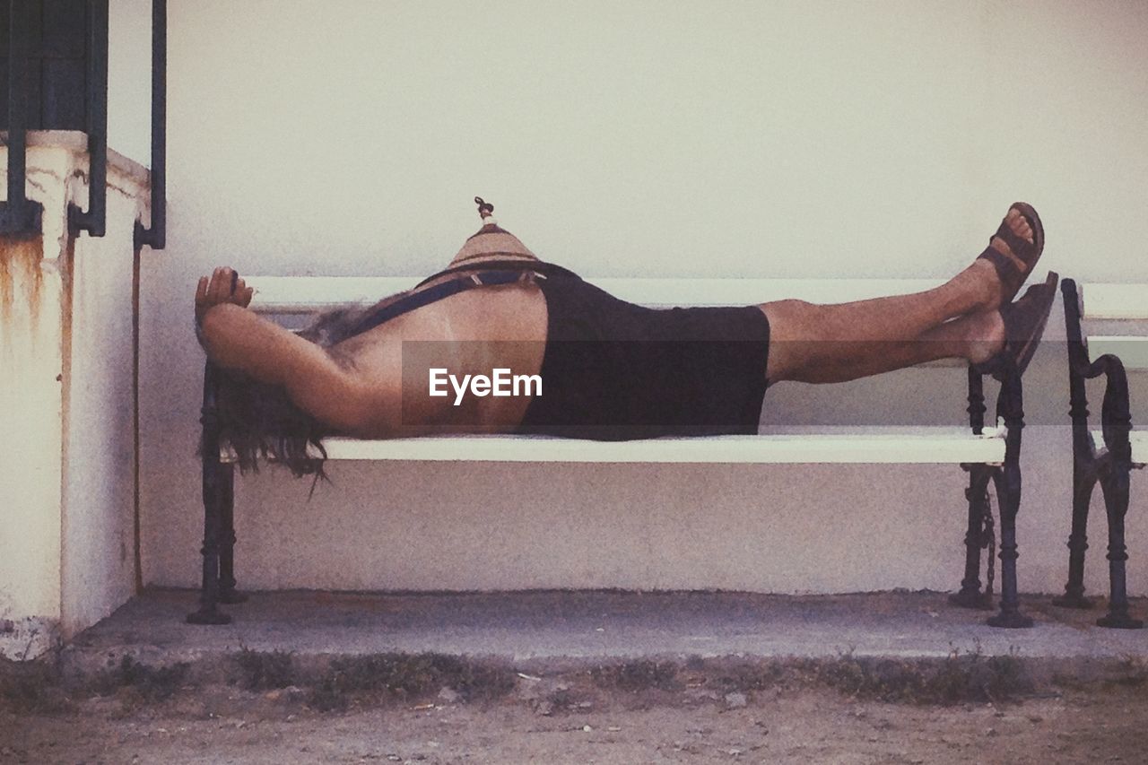 Man lying on bench