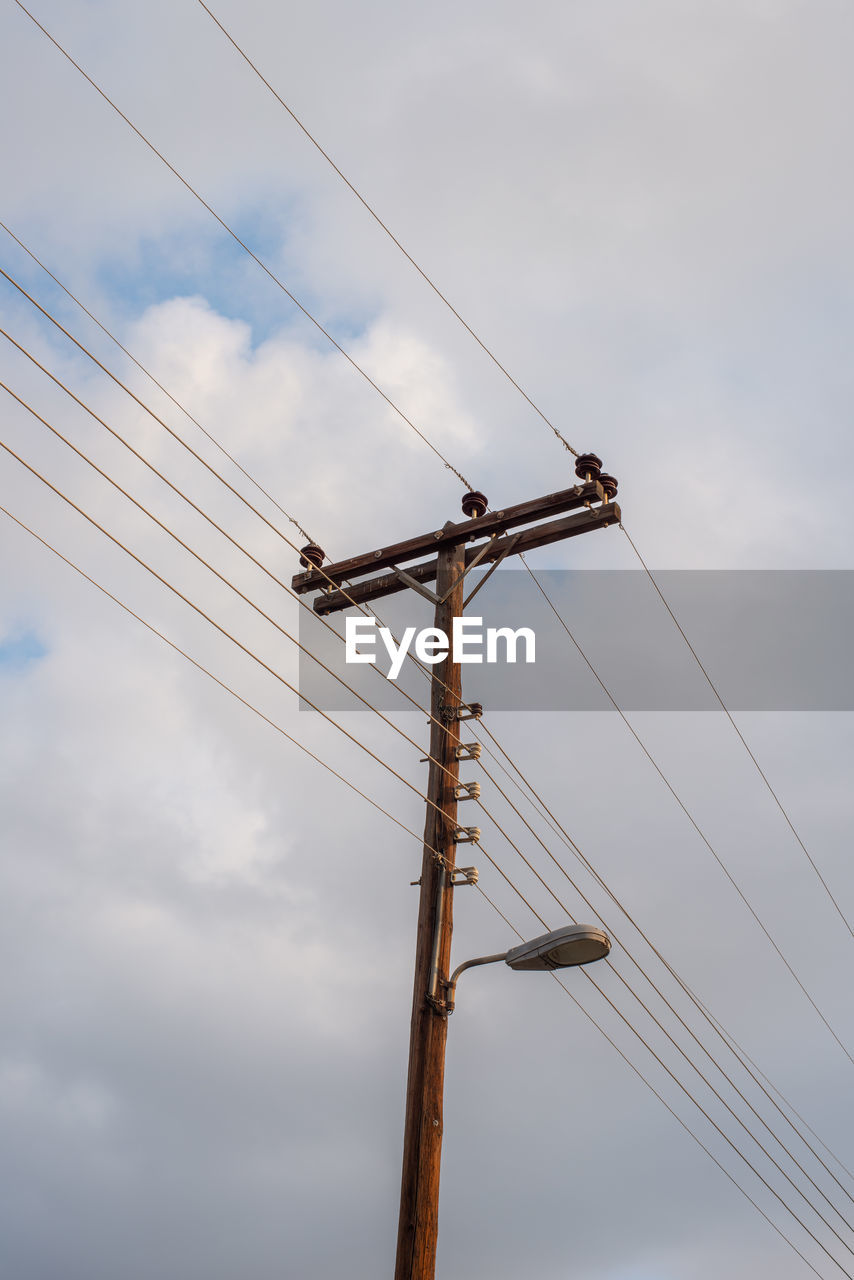 Electric lines on a wooden pole. side view.