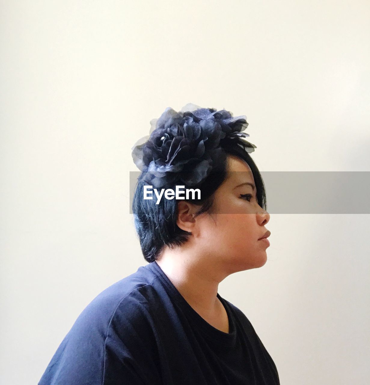 Side view of mature woman looking away against white background