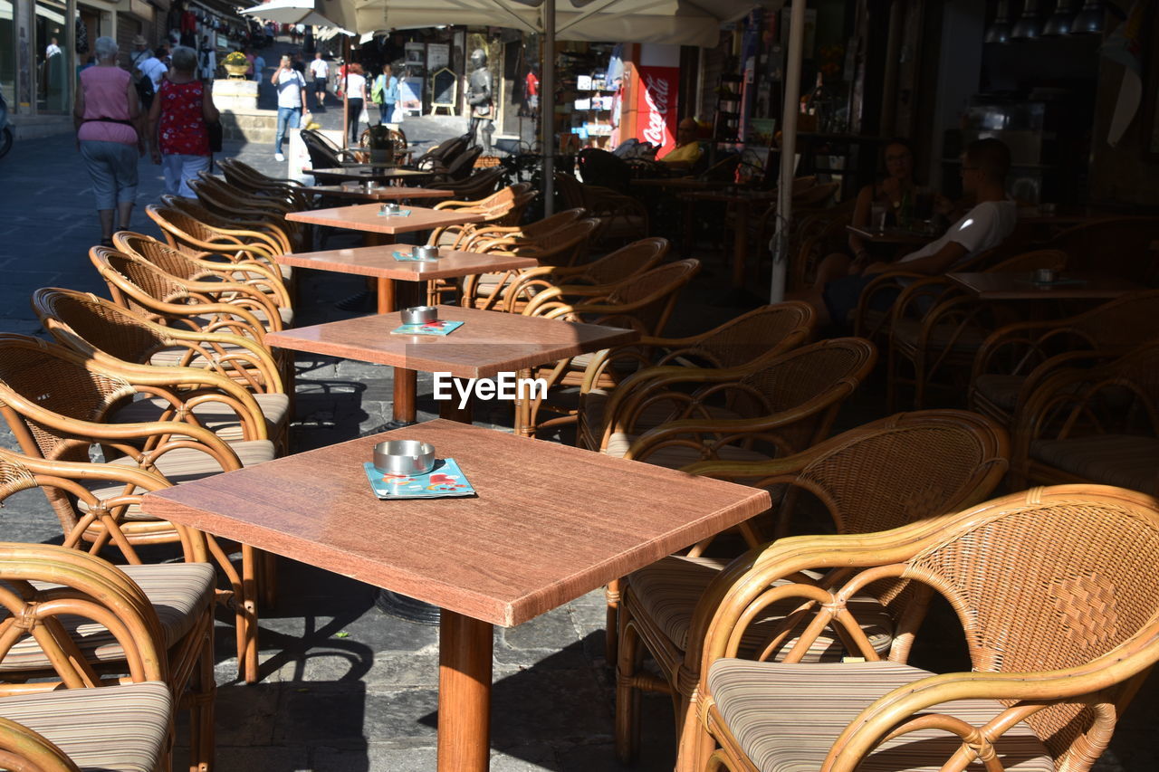 EMPTY CHAIRS AND TABLES AT RESTAURANT