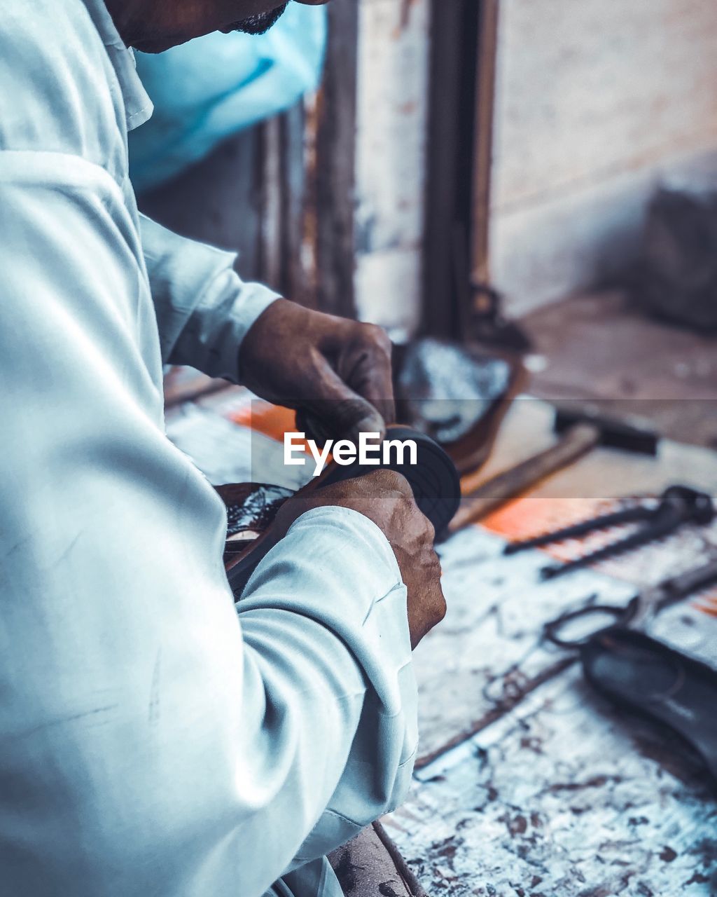 MIDSECTION OF MAN WORKING ON FLOOR