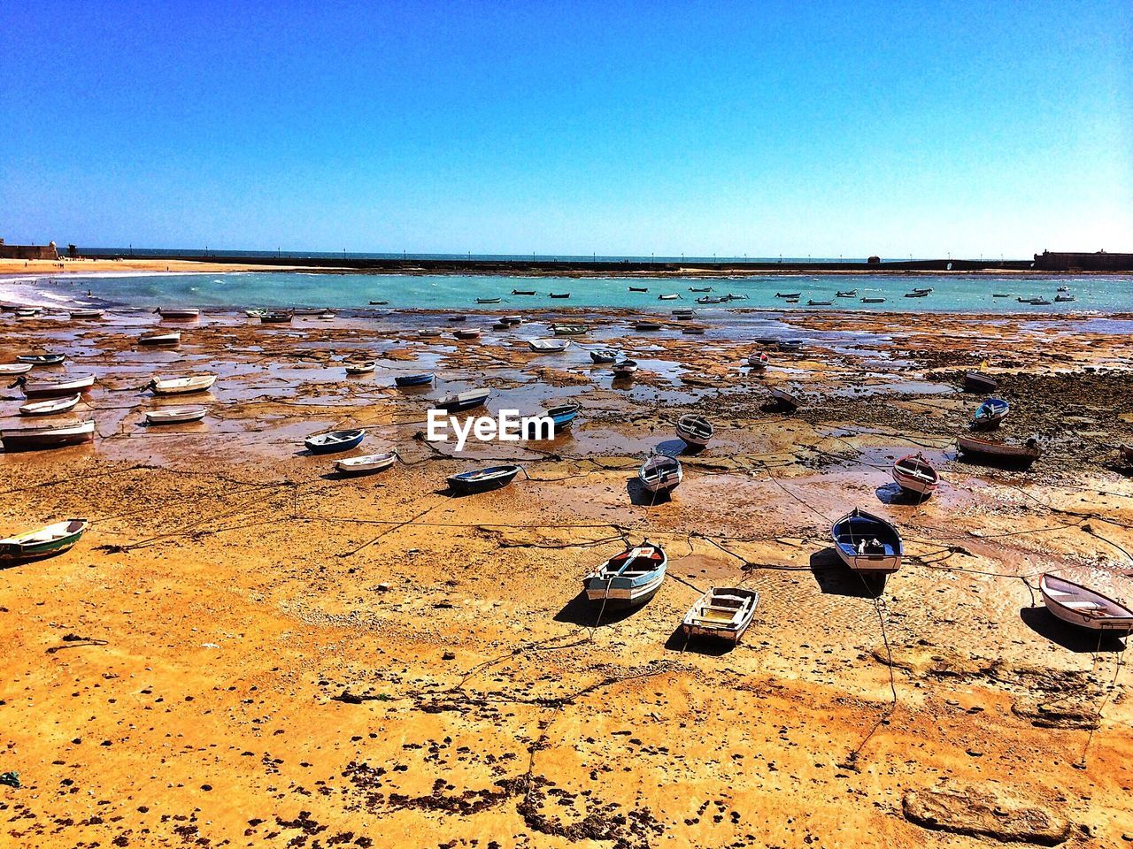 View of beach against clear blue sky