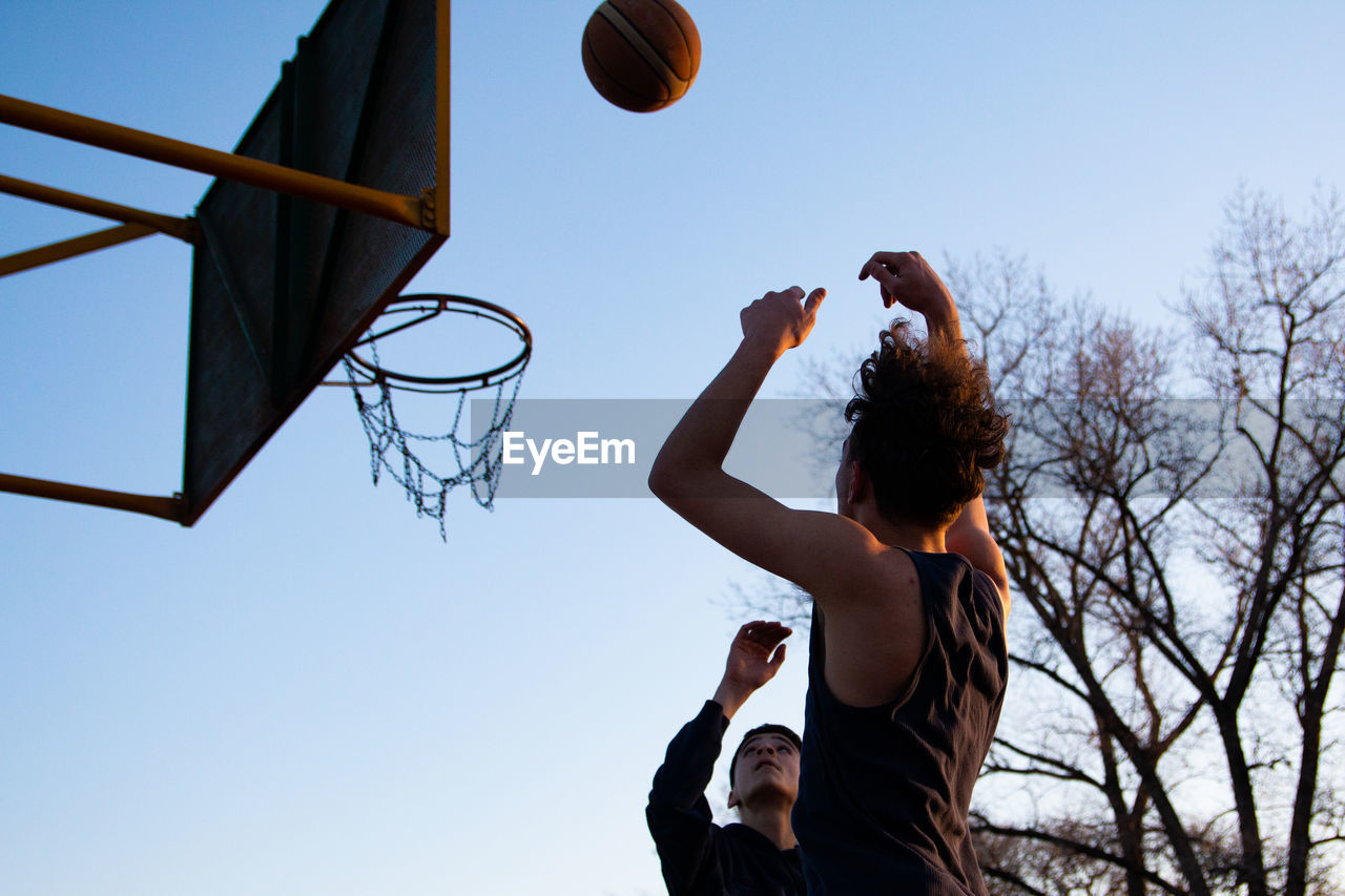 Portrait of teenager boys playing basketball