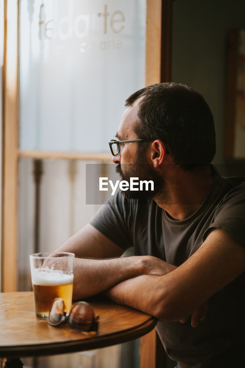 MAN SITTING ON TABLE