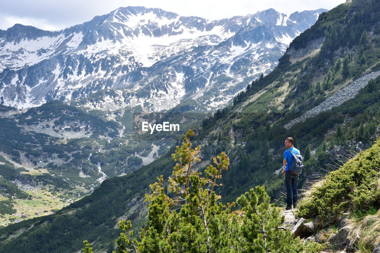 Rear view of man standing on mountain